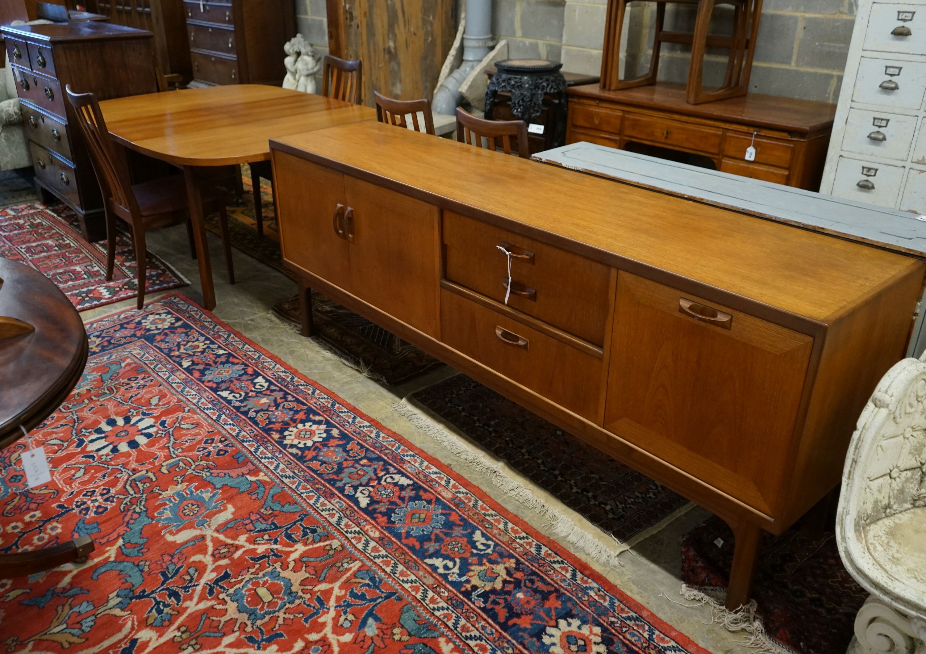 A G Plan teak dining suite comprising extending table, 158cm extended, width 112cm, height 72cm, four chairs and a sideboard
